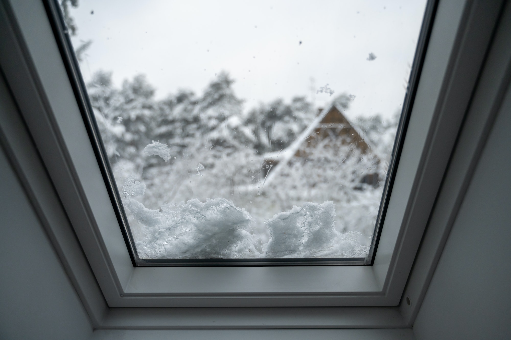 Window on roof covered by snow